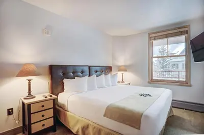 a bedroom with a large white bed and a window at Premier Silver Mill 8229 - 2Br-Walk to Slopes! Kids Ski Free! condo in Keystone