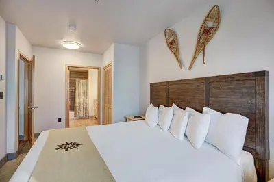 a bedroom with a large white bed with white pillows at Premier Silver Mill 8229 - 2Br-Walk to Slopes! Kids Ski Free! condo in Keystone