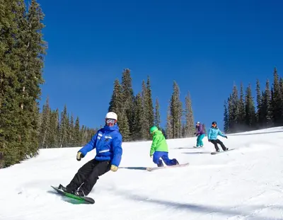 a group of people skiing down a snow covered slope at Premier Silver Mill 8229 - 2Br-Walk to Slopes! Kids Ski Free! condo in Keystone