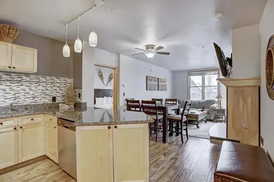 a kitchen and living room with a dining room at Premier Silver Mill 8229 - 2Br-Walk to Slopes! Kids Ski Free! condo in Keystone
