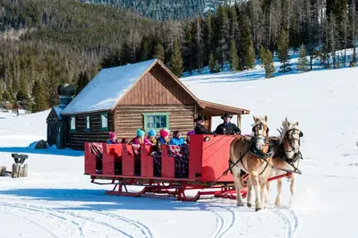 a group of people riding on a horse drawn sleigh at Silver Mill 8260 - 2Br-Walk to Slopes! Kids Ski Free! condo in Keystone
