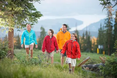 a group of people walking in a field at Silver Mill 8260 - 2Br-Walk to Slopes! Kids Ski Free! condo in Keystone