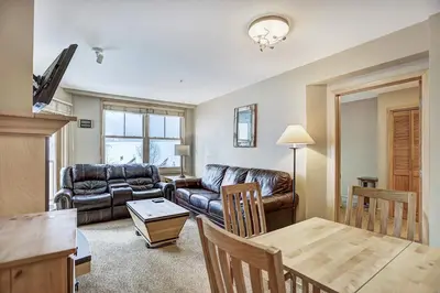 a living room with a leather couch and a table at Silver Mill 8260 - 2Br-Walk to Slopes! Kids Ski Free! condo in Keystone