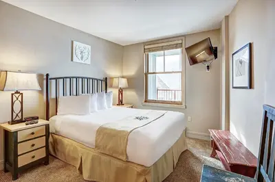 a bedroom with a large bed and a window at Silver Mill 8260 - 2Br-Walk to Slopes! Kids Ski Free! condo in Keystone