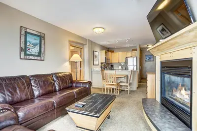 a living room with a leather couch and a fireplace at Silver Mill 8260 - 2Br-Walk to Slopes! Kids Ski Free! condo in Keystone