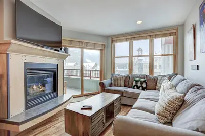 a living room with a couch and a fireplace at Premier Silver Mill 8281 - 2Br-Walk to Slopes! Kids Ski Free! condo in Keystone