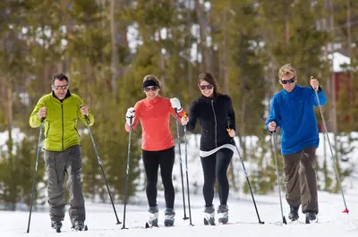 a group of four people on skis in the snow at Premier Silver Mill 8281 - 2Br-Walk to Slopes! Kids Ski Free! condo in Keystone