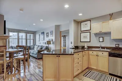 a kitchen and living room with a table and a couch at Premier Silver Mill 8281 - 2Br-Walk to Slopes! Kids Ski Free! condo in Keystone