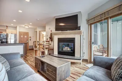 a living room with a fireplace and a tv at Premier Silver Mill 8281 - 2Br-Walk to Slopes! Kids Ski Free! condo in Keystone