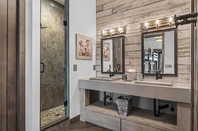 a bathroom with two sinks and a shower at Skyes Peak - Luxury Mountain Retreat with Breathtaking Views in Estes Park