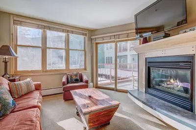 a living room with a fireplace and a tv at Silver Mill 8173 - 1Br-Walk to Slopes! Kids Ski Free! condo in Keystone
