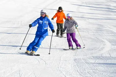 a group of three people on skis in the snow at Silver Mill 8173 - 1Br-Walk to Slopes! Kids Ski Free! condo in Keystone