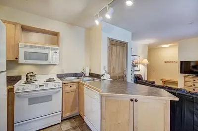 a kitchen with a white stove and a microwave at Silver Mill 8184 - 1Br-Walk to Slopes! Kids Ski Free! condo in Keystone