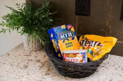 a basket of snacks on a counter with a plant at Close to RMNP, Estes,& Amenities in Estes Park