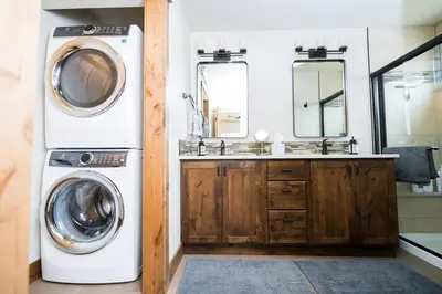 a bathroom with a washing machine and a sink at Close to RMNP, Estes,& Amenities in Estes Park