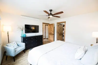 a bedroom with a white bed and a ceiling fan at Close to RMNP, Estes,& Amenities in Estes Park