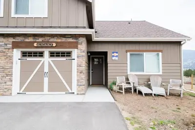 a garage with a garage door with chairs outside at Close to RMNP, Estes,& Amenities in Estes Park
