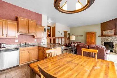 a kitchen and dining room with a wooden table at Buffalo Ridge B107 in Silverthorne