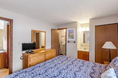 a bedroom with a blue bed and a television at Buffalo Ridge B107 in Silverthorne