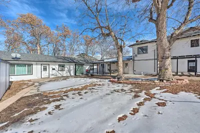 a white house with a tree and a driveway at Multi-Unit Denver Vacation Rental Home! in Denver