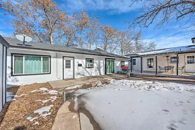 a white house with snow on the driveway at Multi-Unit Denver Vacation Rental Home! in Denver
