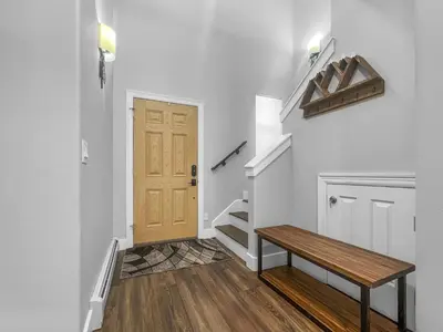 a hallway with a wooden bench and stairs at 928A Lakepoint Circle 3Br 2,5Ba home in Frisco