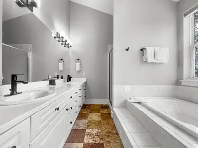 a white bathroom with two sinks and a tub at 928A Lakepoint Circle 3Br 2,5Ba home in Frisco
