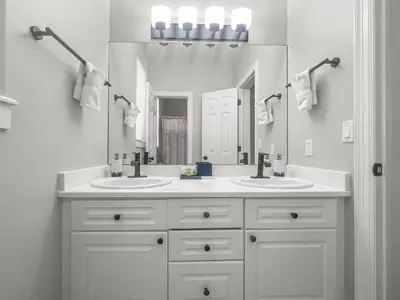 a bathroom with two sinks and a large mirror at 928A Lakepoint Circle 3Br 2,5Ba home in Frisco
