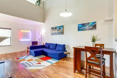 a living room with a blue couch and a table at 4 Mi to Airport Convenient Denver Condo in Aurora