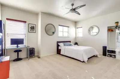 a bedroom with a bed and a ceiling fan at 4 Mi to Airport Convenient Denver Condo in Aurora