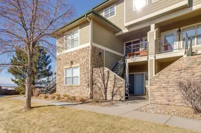 a large house with a staircase in front of it at 4 Mi to Airport Convenient Denver Condo in Aurora