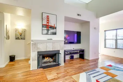 a living room with a fireplace and a tv at 4 Mi to Airport Convenient Denver Condo in Aurora