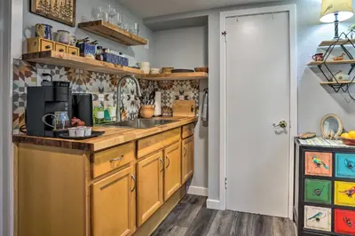 a kitchen with wooden cabinets and a sink at 3 Mi to Dtwn Convenient Denver Apt in Denver