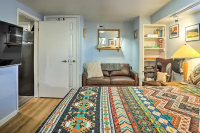 a bedroom with a bed and a living room with a couch at 3 Mi to Dtwn Convenient Denver Apt in Denver