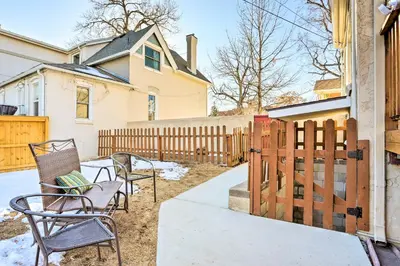 a backyard with chairs and a wooden fence at 3 Mi to Dtwn Convenient Denver Apt in Denver