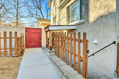 a red door on a house with a fence at 3 Mi to Dtwn Convenient Denver Apt in Denver