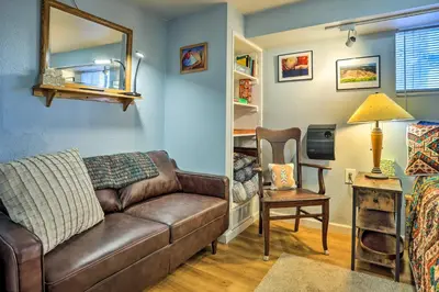 a living room with a brown couch and a chair at 3 Mi to Dtwn Convenient Denver Apt in Denver