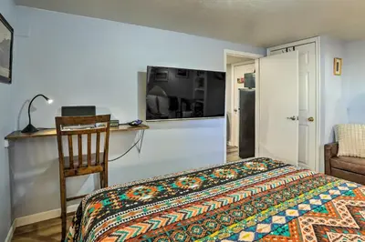 a bedroom with a bed and a desk and a chair at 3 Mi to Dtwn Convenient Denver Apt in Denver