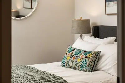 a bedroom with a bed with a pillow and a mirror at The Modern Mountaineer in Bailey