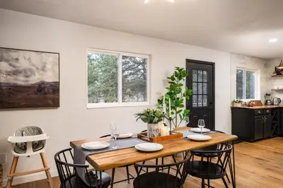 a dining room with a wooden table and chairs at The Modern Mountaineer in Bailey