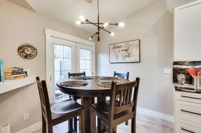 a kitchen and dining room with a table and chairs at Near Red Rocks Golden Getaway with Deck! in Golden