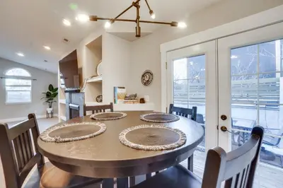 a dining room with a large table and chairs at Near Red Rocks Golden Getaway with Deck! in Golden