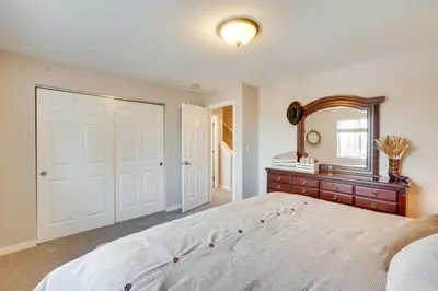 a bedroom with a large bed and a mirror at Near Red Rocks Golden Getaway with Deck! in Golden