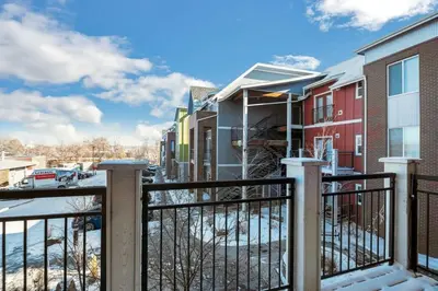 a balcony with a fence and some buildings at Fully Furnished 2BR Centrally Located with Pool in Greeley
