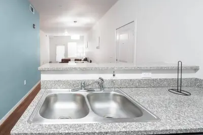 a kitchen with a sink and a counter top at Fully Furnished 2BR Centrally Located with Pool in Greeley