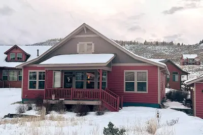 a red house with a porch in the snow at Granby Ranch Ski & Golf Getaway - Pank's Peak in Granby