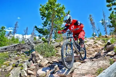 a man riding a bike on a rocky trail at Granby Ranch Ski & Golf Getaway - Pank's Peak in Granby