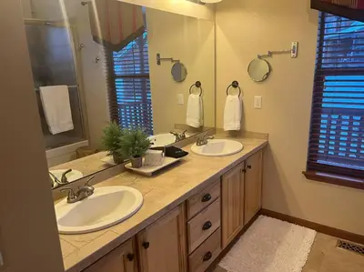 a bathroom with two sinks and a large mirror at Granby Ranch Ski & Golf Getaway - Pank's Peak in Granby