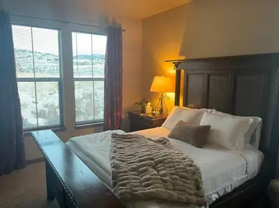 a bedroom with a large bed with a wooden headboard at Granby Ranch Ski & Golf Getaway - Pank's Peak in Granby