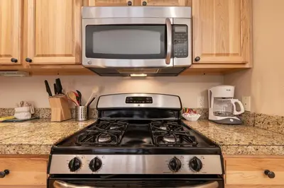 a microwave above a stove in a kitchen at Telemark Townhomes Unit 514 in Winter Park